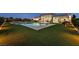 Resort-style backyard with a sparkling pool, lush green lawn, and comfortable outdoor seating at 5400 Mello Ave, Las Vegas, NV 89131