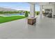 Backyard with a pool, green lawn, modern patio, and outdoor fire pit for year-round enjoyment at 5400 Mello Ave, Las Vegas, NV 89131