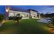 Backyard with a plush lawn, modern patio furniture, and a sparkling pool for outdoor entertainment at 5400 Mello Ave, Las Vegas, NV 89131