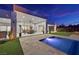 Backyard pool and patio with modern furniture on a meticulously maintained lawn at dusk at 5400 Mello Ave, Las Vegas, NV 89131