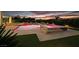 Backyard features a pool and spa with custom lighting, surrounded by a stone patio and well-maintained landscaping at 5400 Mello Ave, Las Vegas, NV 89131