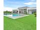 Beautiful backyard features a sparkling pool, lush lawn, and modern architecture creating a luxurious outdoor oasis at 5400 Mello Ave, Las Vegas, NV 89131