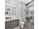 Well-lit bathroom with a modern vanity, a glass-enclosed shower, and contemporary fixtures at 5400 Mello Ave, Las Vegas, NV 89131