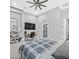 Modern bedroom with integrated shelving, TV, ceiling fan, and open access to walk-in closet at 5400 Mello Ave, Las Vegas, NV 89131