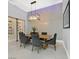 Dining room with a modern chandelier, wood table and a wine cellar at 5400 Mello Ave, Las Vegas, NV 89131