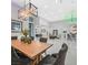 Dining room with modern lighting, a wooden table, and access to the bar area at 5400 Mello Ave, Las Vegas, NV 89131