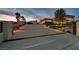 Long driveway and modern home with professional landscaping, including ornamental grasses and stone at 5400 Mello Ave, Las Vegas, NV 89131
