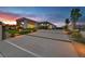 Beautiful modern home featuring a long driveway with manicured landscaping and elegant outdoor lighting at 5400 Mello Ave, Las Vegas, NV 89131