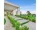 Stunning modern home showcasing the manicured front yard with lighted walkways leading to a grand entrance at 5400 Mello Ave, Las Vegas, NV 89131