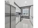 Sleek laundry room features stainless steel appliances and minimalist white cabinets at 5400 Mello Ave, Las Vegas, NV 89131