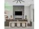 Living room featuring a modern fireplace, dark grey sofa and decorative accents at 5400 Mello Ave, Las Vegas, NV 89131