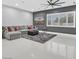 Spacious living room with a large sectional sofa, a ceiling fan, and bright windows filling the room with natural light at 5400 Mello Ave, Las Vegas, NV 89131