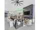 Open concept living room with fireplace, bar and modern decor, and access to front door at 5400 Mello Ave, Las Vegas, NV 89131