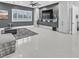Open-concept living area with contemporary decor, large windows, and sleek flooring at 5400 Mello Ave, Las Vegas, NV 89131
