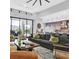 Open-concept living area with luxury finishes, modern furnishings, and glass doors to the outdoors at 5400 Mello Ave, Las Vegas, NV 89131