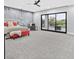 Bright main bedroom featuring a textured accent wall, ceiling fan, and sliding glass doors to outdoor area at 5400 Mello Ave, Las Vegas, NV 89131
