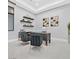 Stylish home office with modern furnishings, floating shelves, and ample natural light for a productive workspace at 5400 Mello Ave, Las Vegas, NV 89131