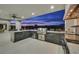 Outdoor kitchen featuring a grill, bar seating, stainless steel appliances, and backyard views at 5400 Mello Ave, Las Vegas, NV 89131