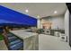 Covered outdoor kitchen with granite counters, bar seating, and professional-grade stainless steel appliances at 5400 Mello Ave, Las Vegas, NV 89131
