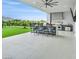 Outdoor kitchen with grill, bar seating, stainless steel appliances, and lush backyard views at 5400 Mello Ave, Las Vegas, NV 89131