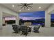 Modern patio with a fire pit and seating, showcasing mountain views and a pool at 5400 Mello Ave, Las Vegas, NV 89131