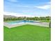 Outdoor view of large pool and manicured lawn, an ideal spot for relaxation and recreation at 5400 Mello Ave, Las Vegas, NV 89131