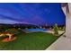 Inviting pool surrounded by manicured greenery, creating a peaceful outdoor oasis at twilight at 5400 Mello Ave, Las Vegas, NV 89131
