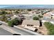 An aerial view shows a home with a landscaped backyard, covered patio, and mountain views at 5480 Lincolnwood Ct, Pahrump, NV 89061