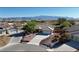 Stunning aerial view of a single-story home with a well-maintained yard and beautiful mountain views in the distance at 5480 Lincolnwood Ct, Pahrump, NV 89061