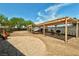 This spacious backyard features a large pergola, stone patio, mature trees and a BBQ grill at 5480 Lincolnwood Ct, Pahrump, NV 89061