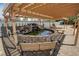 Backyard featuring a charming water feature beneath a pergola for added ambiance at 5480 Lincolnwood Ct, Pahrump, NV 89061