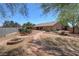 Large backyard showcasing a stone pathway, garden beds, and potential for outdoor entertaining at 5480 Lincolnwood Ct, Pahrump, NV 89061