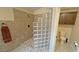 Bathroom featuring a tiled shower with glass block and a toilet at 5480 Lincolnwood Ct, Pahrump, NV 89061