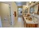 Bathroom features double sinks, vanity, decorative mirrors, and tile flooring at 5480 Lincolnwood Ct, Pahrump, NV 89061