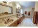 Elegant bathroom with double sinks, decorative mirrors, and tiled accents at 5480 Lincolnwood Ct, Pahrump, NV 89061