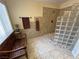 Bathroom with tile floors, glass block shower, and a wooden bench by the window at 5480 Lincolnwood Ct, Pahrump, NV 89061