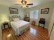 Bedroom features a bed, windows and hardwood floors at 5480 Lincolnwood Ct, Pahrump, NV 89061
