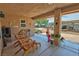Relaxing covered patio with comfortable seating, potted plants, and a decorative outdoor space perfect for entertaining at 5480 Lincolnwood Ct, Pahrump, NV 89061