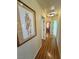 Hallway featuring lovely hardwood floors, and decorated walls at 5480 Lincolnwood Ct, Pahrump, NV 89061