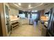 Open concept kitchen with stainless steel appliances and white cabinets at 5480 Lincolnwood Ct, Pahrump, NV 89061