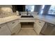 Gourmet sink with sleek faucet, quartz countertops, and custom white cabinetry at 5480 Lincolnwood Ct, Pahrump, NV 89061