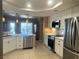Open concept kitchen with white cabinets, marble countertops, and stainless steel appliances at 5480 Lincolnwood Ct, Pahrump, NV 89061