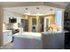 Modern kitchen with white cabinets, stainless steel appliances, and unique hanging lights at 5480 Lincolnwood Ct, Pahrump, NV 89061