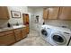 Functional laundry room with washer, dryer, cabinets, and sink at 5480 Lincolnwood Ct, Pahrump, NV 89061
