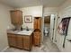 Bright laundry room with tiled floor, sink, and storage at 5480 Lincolnwood Ct, Pahrump, NV 89061