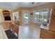 Bright living area featuring tile floors, an entertainment center, and views of the outdoors at 5480 Lincolnwood Ct, Pahrump, NV 89061