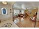 Bright living room with hardwood floors, large windows, and comfortable seating, perfect for relaxation at 5480 Lincolnwood Ct, Pahrump, NV 89061
