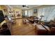 Spacious living room featuring hardwood floors, ceiling fan, and large window at 5480 Lincolnwood Ct, Pahrump, NV 89061