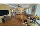 Spacious living room featuring hardwood floors, ceiling fan, and a large window at 5480 Lincolnwood Ct, Pahrump, NV 89061