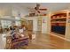 Spacious living room featuring hardwood floors, comfortable leather seating, and neutral paint scheme at 5480 Lincolnwood Ct, Pahrump, NV 89061